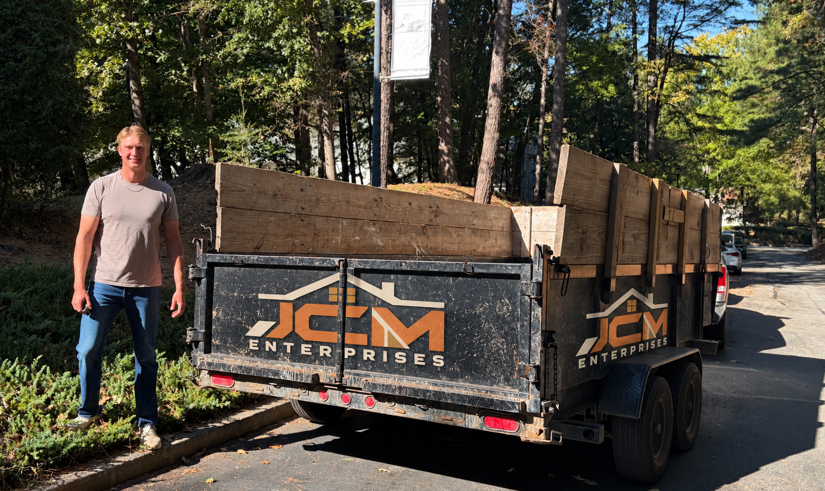 Jake Mason standing beside the JCM Enterprises dump trailer